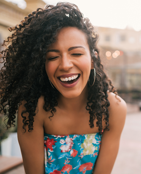 Close up woman with blue dress laughing