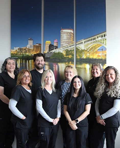 Multiple team members standing in front of picture of city