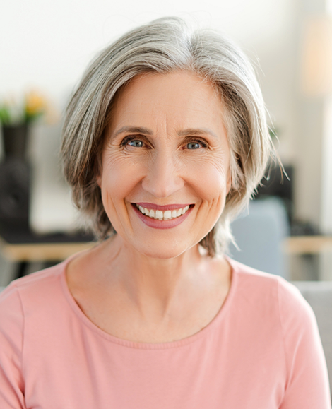 Senior woman in pink shirt smiling