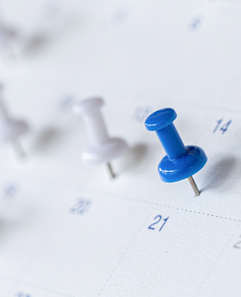 Close up of thumbtacks in calendar
